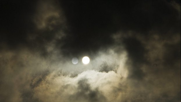 Timelapse sun behind clouds